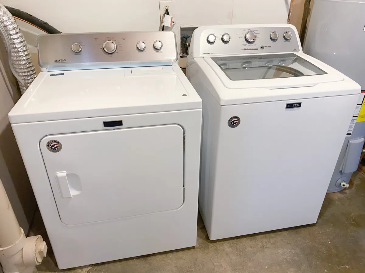 A well-organized laundry area equipped with a washing machine and dryer, set up for practical household chores and maintaining a tidy environment during longer stays.